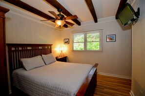 A bedroom with a bed, a ceiling fan, a window with blinds, and a television mounted on the wall. - Pet-Friendly Mountain Retreat, Fire Pit + 2 Decks (Banner Elk)