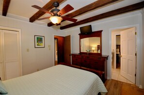 A bedroom with a bed, a dresser, a ceiling fan, and a door leading to another room. - Pet-Friendly Mountain Retreat, Fire Pit + 2 Decks (Banner Elk)