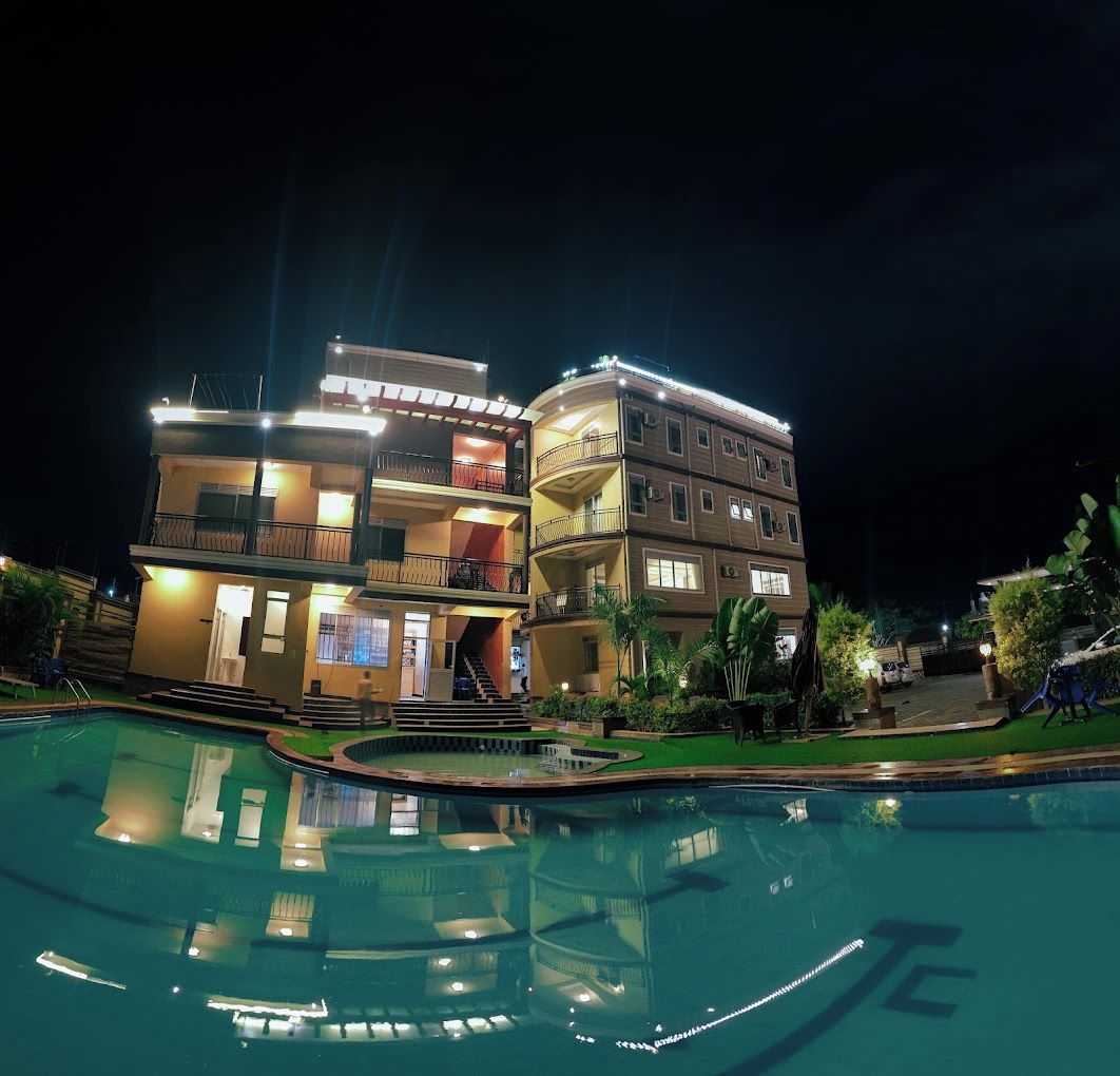 A multi-story hotel with a swimming pool in the foreground.
