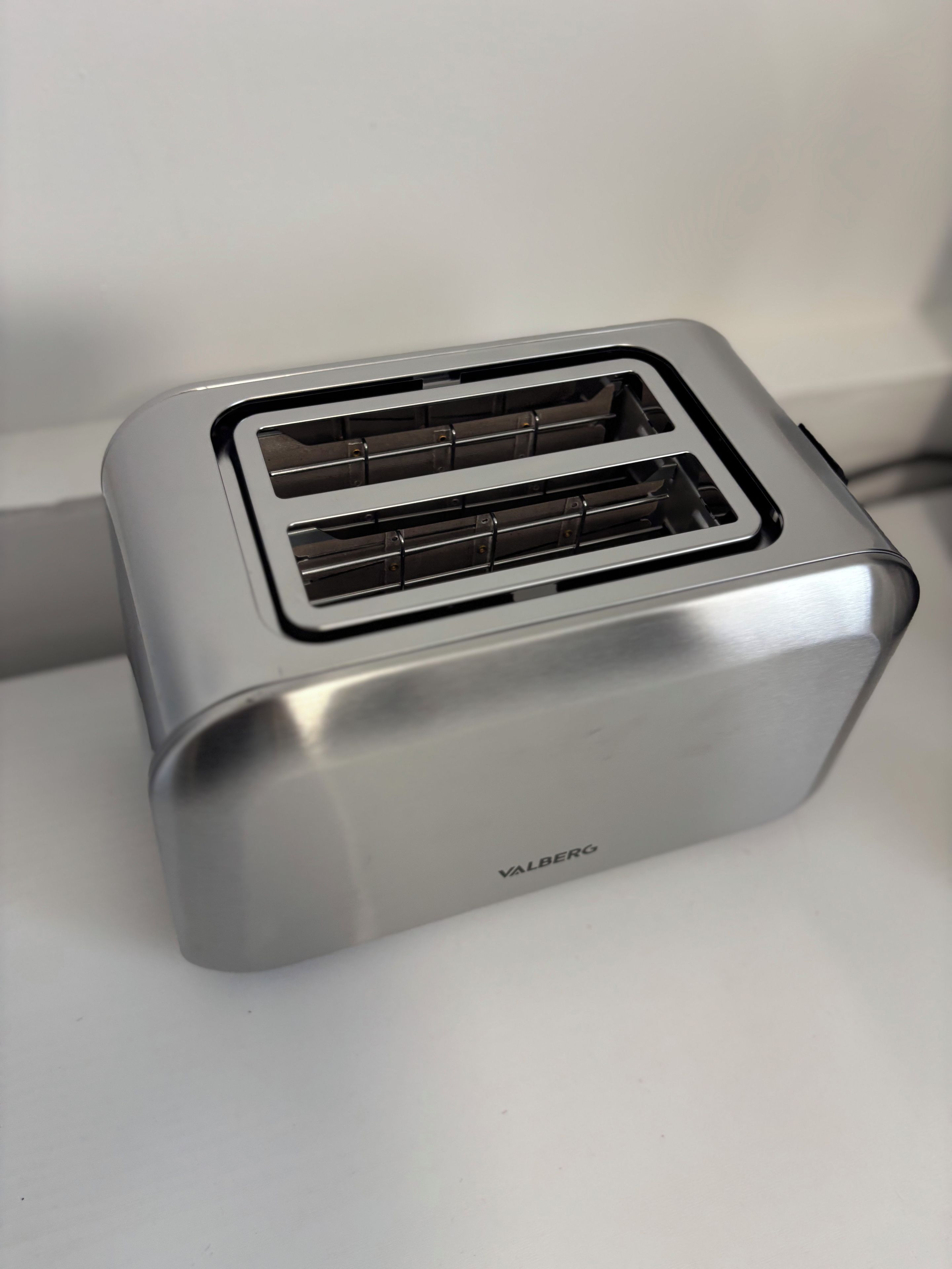 A silver toaster with a brand name visible on its side.