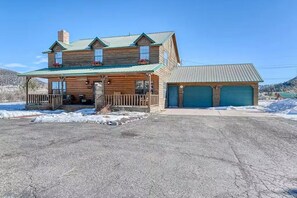 A two-story log cabin with a porch and a garage. - South Fork Cabin Near Skiing, Hiking & Fishing (South Fork)
