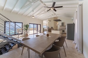 A spacious kitchen with a large island, modern appliances, and a view of the ocean. - Sunkiss Villa in Cole Bay with breathtaking views (Koolbaai)