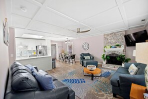 A modern living room with a sofa, coffee table, and fireplace. - Backyard OASIS w/ Putting Green, Patio & Pool! (Hilton Head Island)