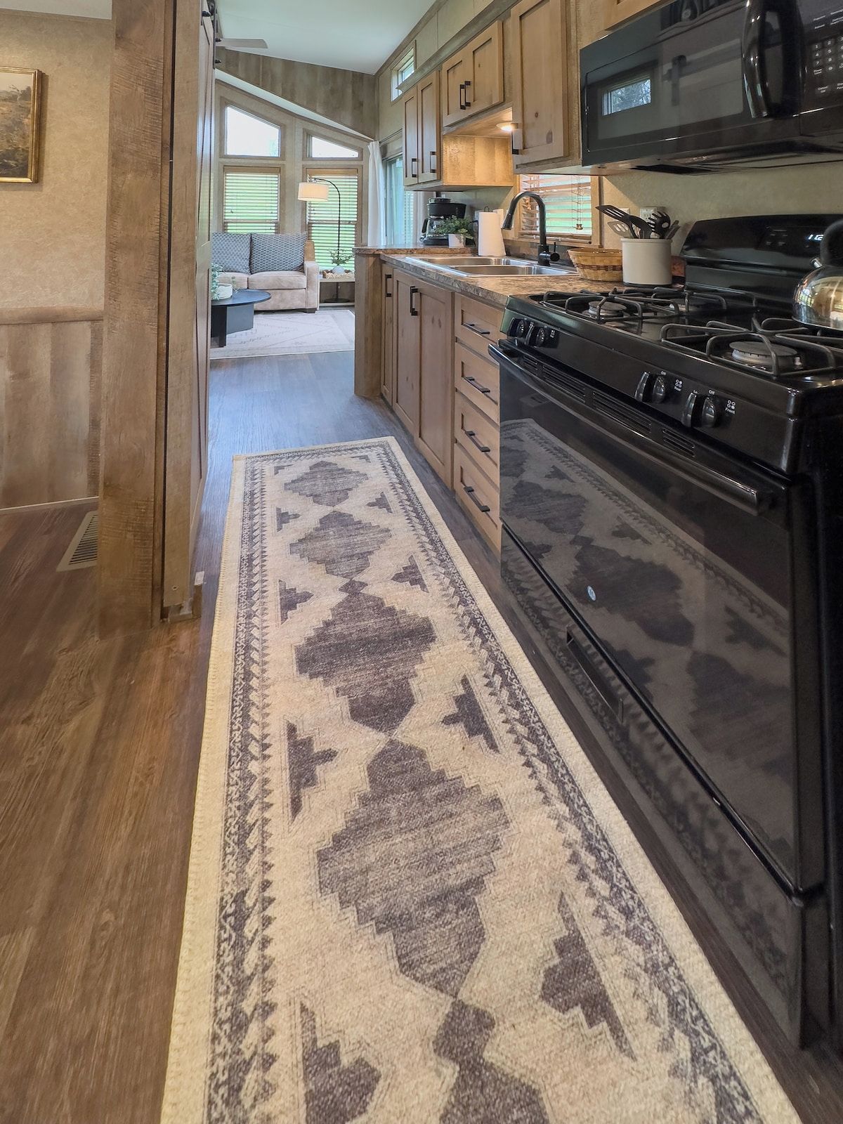 A kitchen with a large stove, microwave, and wooden cabinets.