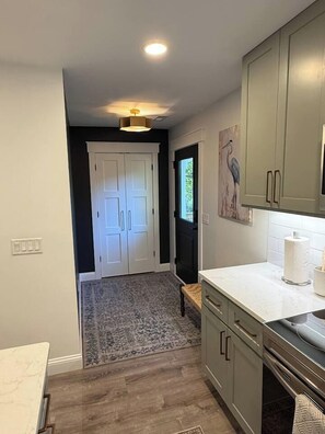 A kitchen with a marble countertop, a built-in oven, and a window. - Private Downtown Bluffton Carriage House (Bluffton)