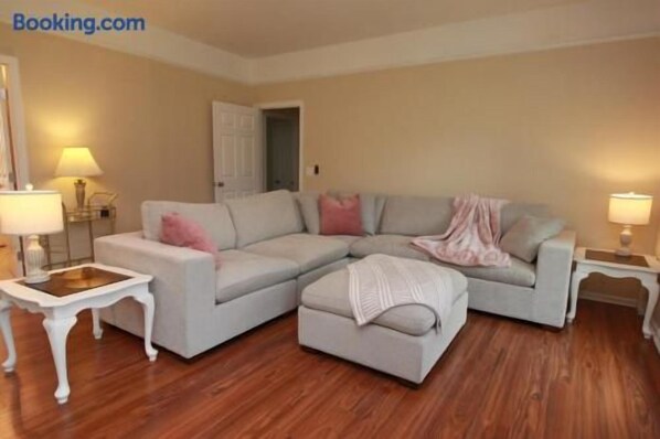 Bright, cozy living room with large sectional and warm stylish touches