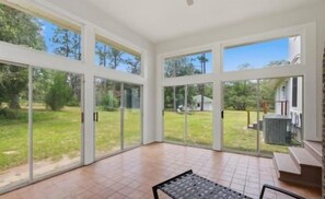 Bright sunroom with panoramic backyard views and abundant natural light