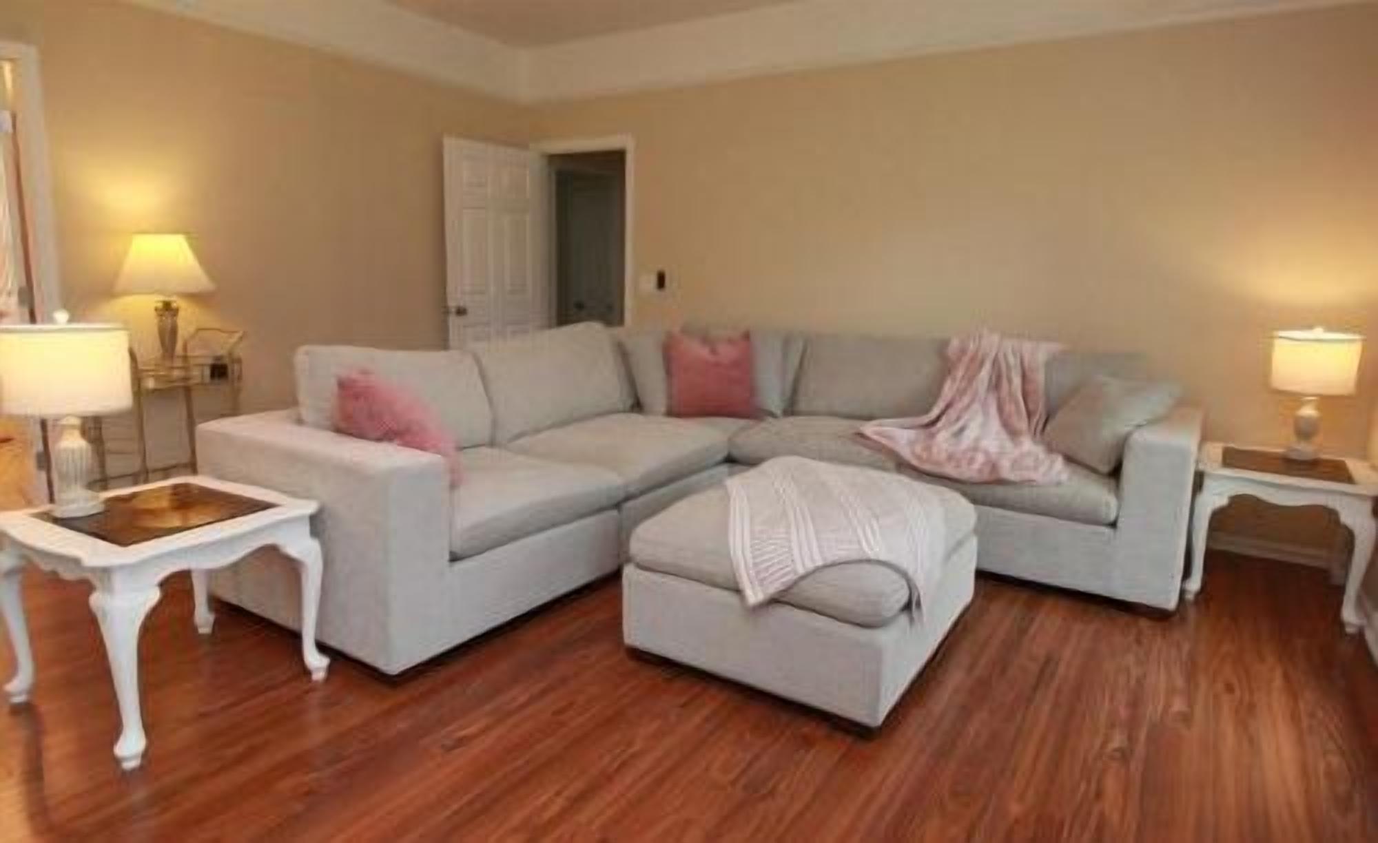 Bright, cozy living room with large sectional and warm stylish touches