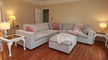 Bright, cozy living room with large sectional and warm stylish touches