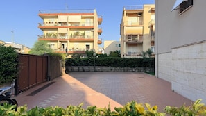 A courtyard with a paved floor, surrounded by buildings with balconies and windows. - Apartment 2 minutes from the ocean, public beach, and home amenities (Terracina)