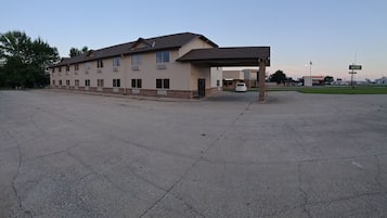 A two-story building with a covered parking area.