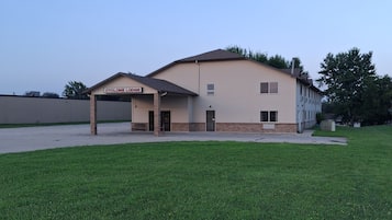 A building with a sign reading 'Cyclone Lodge' and a covered parking area.