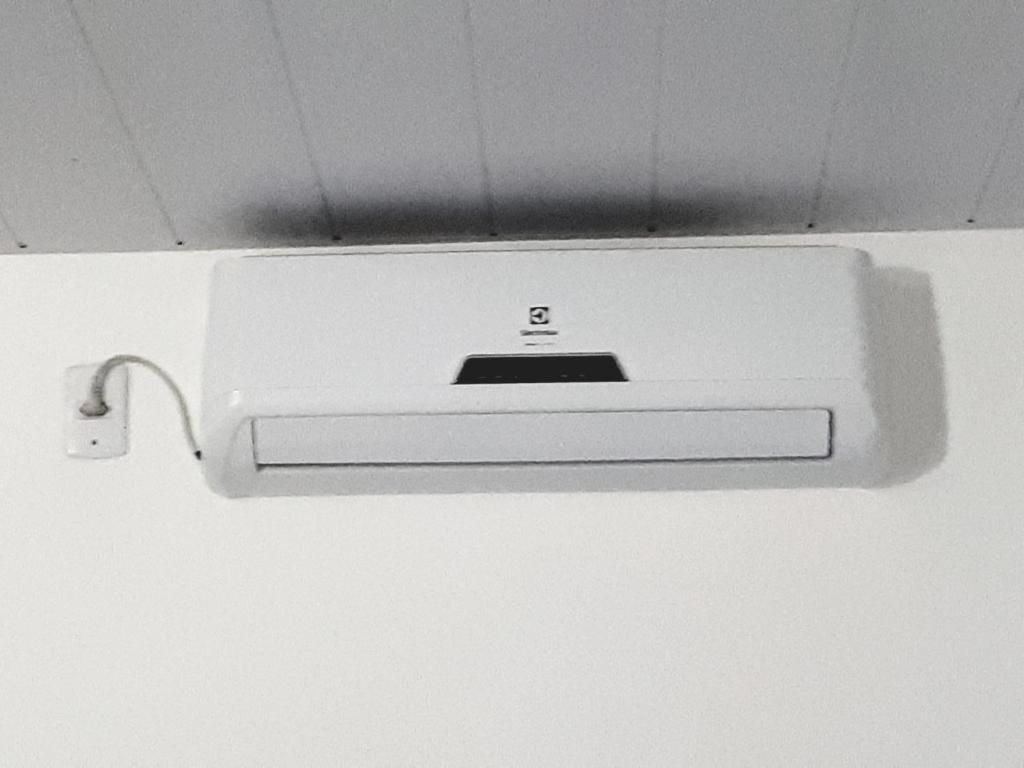 A white air conditioning unit mounted on a wall.