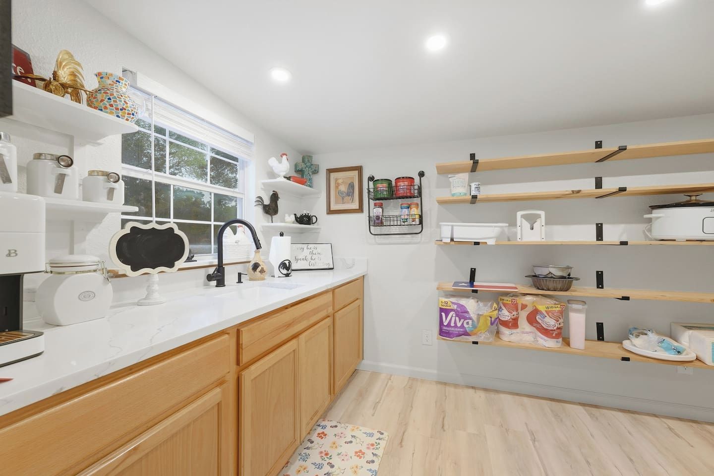 A kitchen with wooden cabinets, a white countertop, and various kitchen appliances.