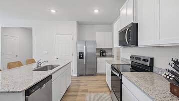 Plenty of counter space, a dishwasher, and a deep sink for easy cleanup
