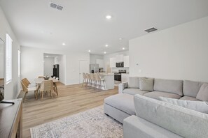 Open-concept main level where living, dining, and kitchen all flow together - Courtside Manor, 5BR Across from Berry Tennis (Rome)