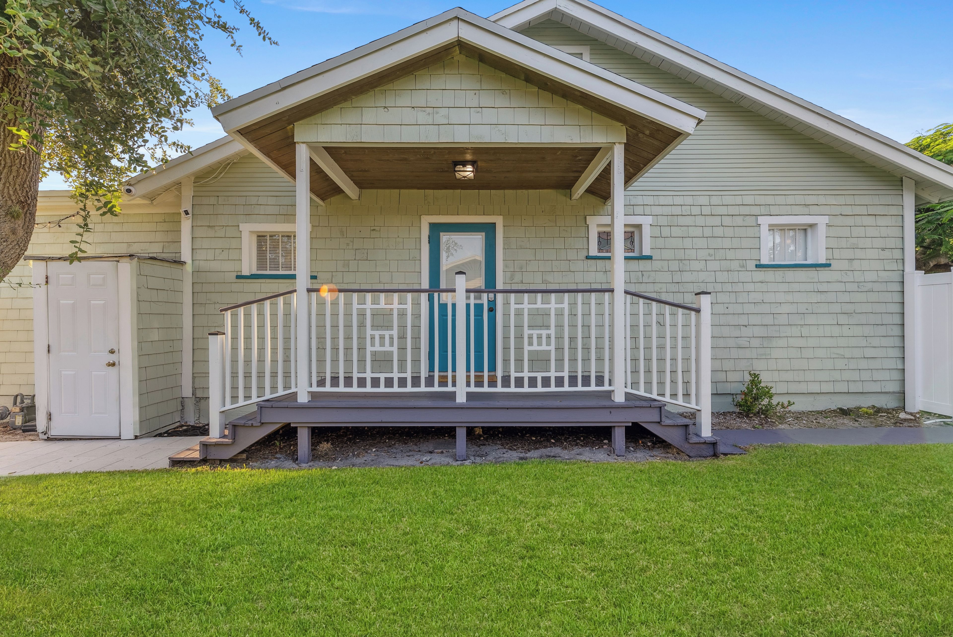 A single-story house with a front porch, a door, and a small window.