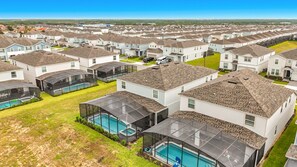 A residential area with multiple houses, each with a private pool and a covered outdoor area. - Windsor Island | 10BR Luxury Haven + Game Room (Davenport)