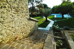 A stone staircase leading to a pool area with a well-maintained lawn and a tree. - VILLA ANNA: HEATED POOL, 2 OUTDOOR HOT TUBS, SAUNA, AND GYM (Sant'Ippolito)