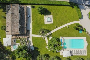 An aerial view of a property with a swimming pool, a covered patio area, and a stone building. - VILLA ANNA: HEATED POOL, 2 OUTDOOR HOT TUBS, SAUNA, AND GYM (Sant'Ippolito)