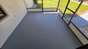 A room with a grey floor, a window, and a door leading outside. - Waterfront Canal home with direct access to the Gulf.  2 Boat Slips and Dock. (Hudson)