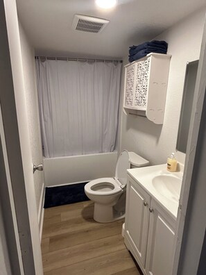 Ein Badezimmer mit Toilette, Waschbecken und Dusche.