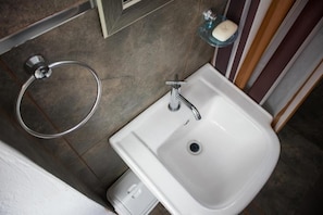 A bathroom with a white sink, a towel ring, and a soap dish. - Lunawasi Hospedaje (Lunahuana)