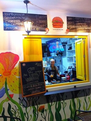 A food stall with a menu board above and a chalkboard menu to the left. - Lunawasi Hospedaje (LUNAHUANA)