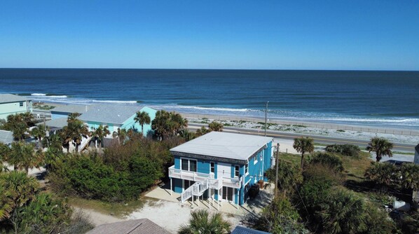 A coastal property with a beachfront view, a balcony, and a road leading to the beach. - Ocean Front Flagler Beach Home (Flagler Beach)