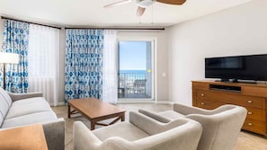 A hotel room with a balcony, a television, a sofa, and a coffee table. - 2BR Deluxe at Club Wyndham Majestic Sun with Partial Ocean Views in Destin (Miramar Beach)