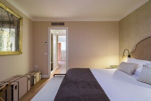 A hotel room with a bed, bedside table, lamp, and a view of the hallway. - Charm and comfort in the heart of Taormina: 3 bedrooms and a private terrace (Taormina)