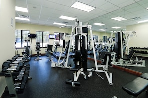 A gym with various exercise equipment, treadmills, and dumbbells. - Orlando Emerald Dream House (Kissimmee)