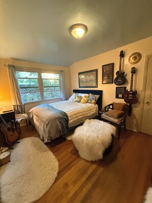 A bedroom with a bed, a guitar, a drum, and a window with curtains. - Libby Rock 'n' Roll Room walk to the bowl. Decorated in family rock memorabilia (Ojai)