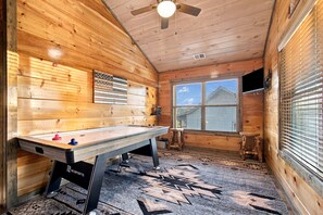 A room with a pool table, a ceiling fan, a window with blinds, and a mounted television. - Cozy Cabin Near Dollywood & Pigeon Forge w/ Hot Tub (Sevierville)
