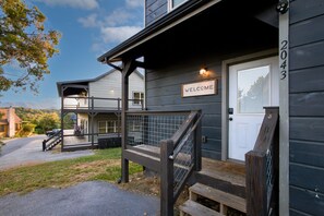 A wooden house with a 'WELCOME' sign, a front porch with steps, and a mailbox. - Cozy Cabin Near Dollywood & Pigeon Forge w/ Hot Tub (Sevierville)