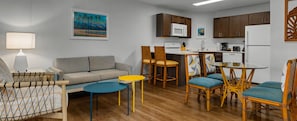 A compact living space with a sofa, dining table, chairs, kitchen area, and a lamp. - 3-BR 2-bath condo at Worldmark Kihei Resort, best beach across the street (Kihei)