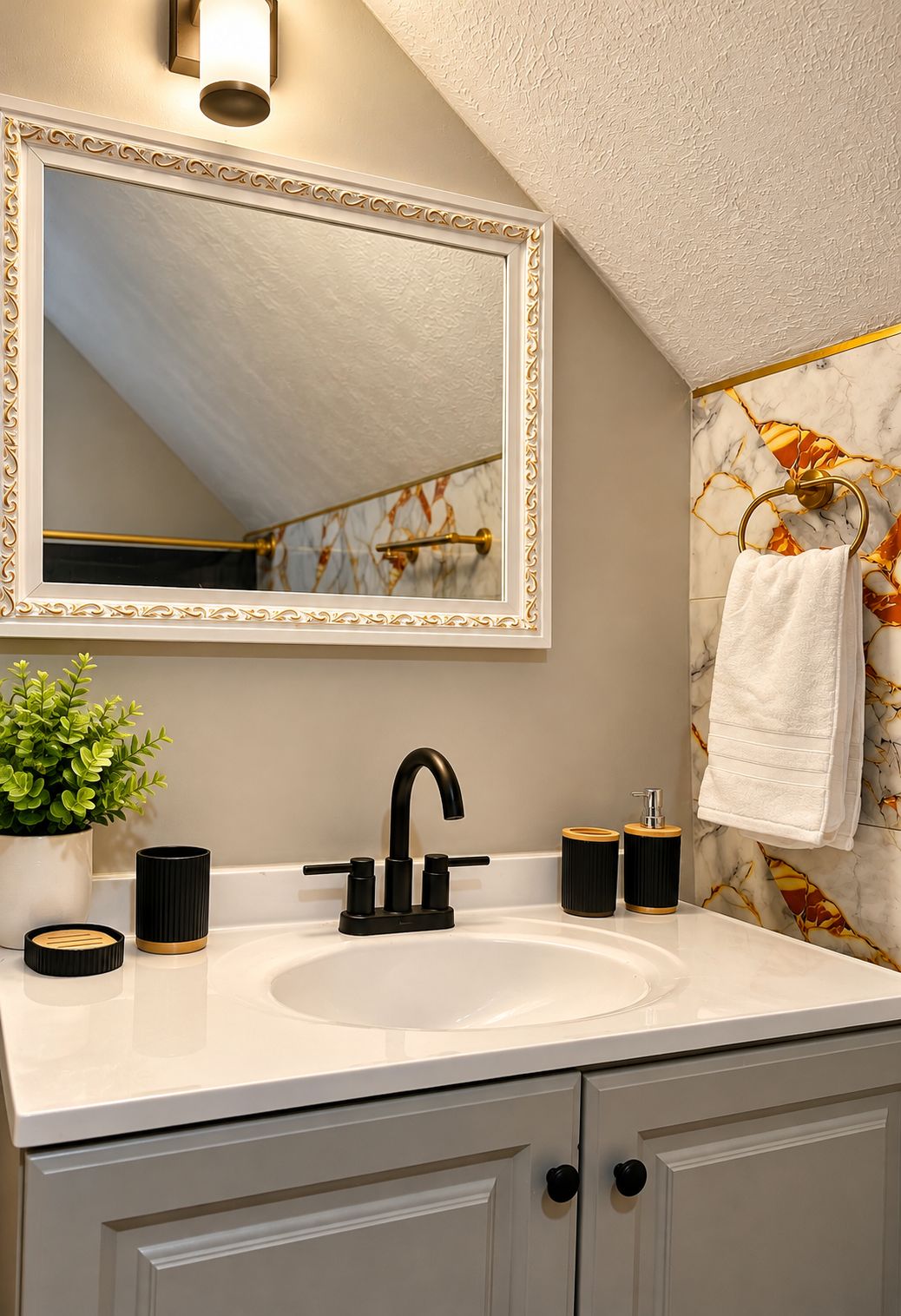 A bathroom with a white sink, black faucet, and a mirror with a gold frame.
