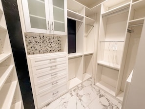 A walk-in closet with open shelving, drawers, and hanging space. - Pool & Hot Tub / 4 BR 4 BA / Outdoor Living (Tucson)