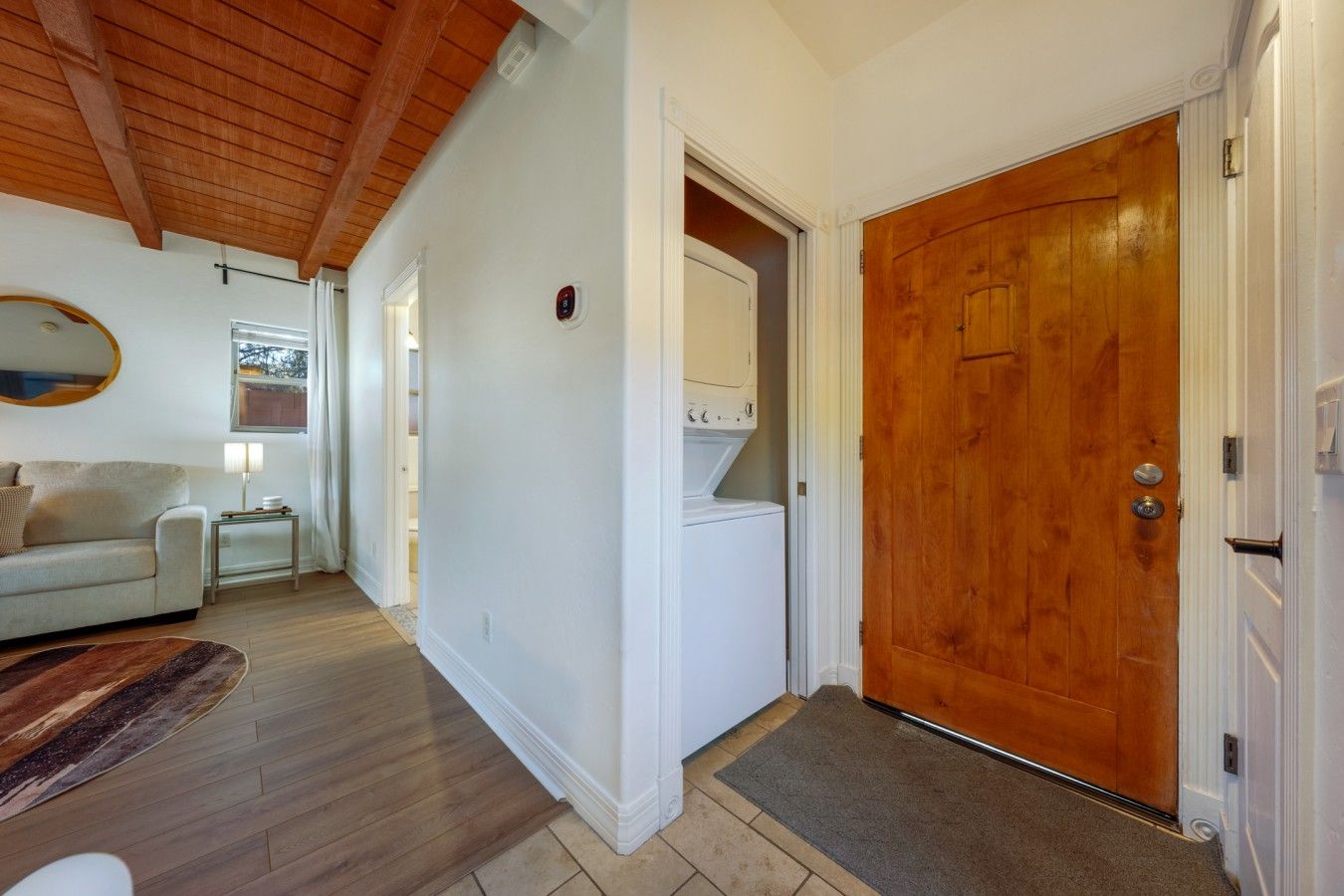 Entrance and laundry closet with washer and dryer available to use during your stay