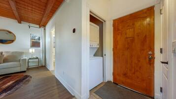 Entrance and laundry closet with washer and dryer available to use during your stay