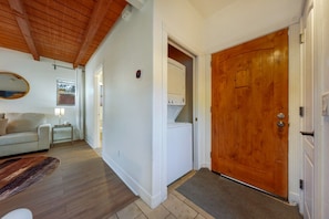Entrance and laundry closet with washer and dryer available to use during your stay
