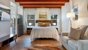 Beautiful open space with cozy queen bed, smart TV, and comfortable couch