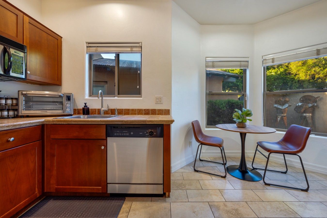 Lovely dining area for two with views of the fenced backyard