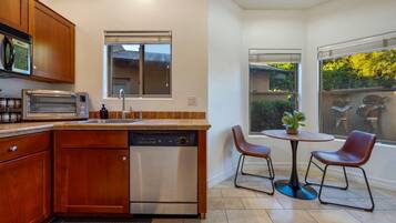 Lovely dining area for two with views of the fenced backyard