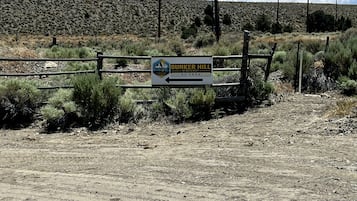 A sign for Bunker Hill Hideaway RV Park with a dirt path leading to it.