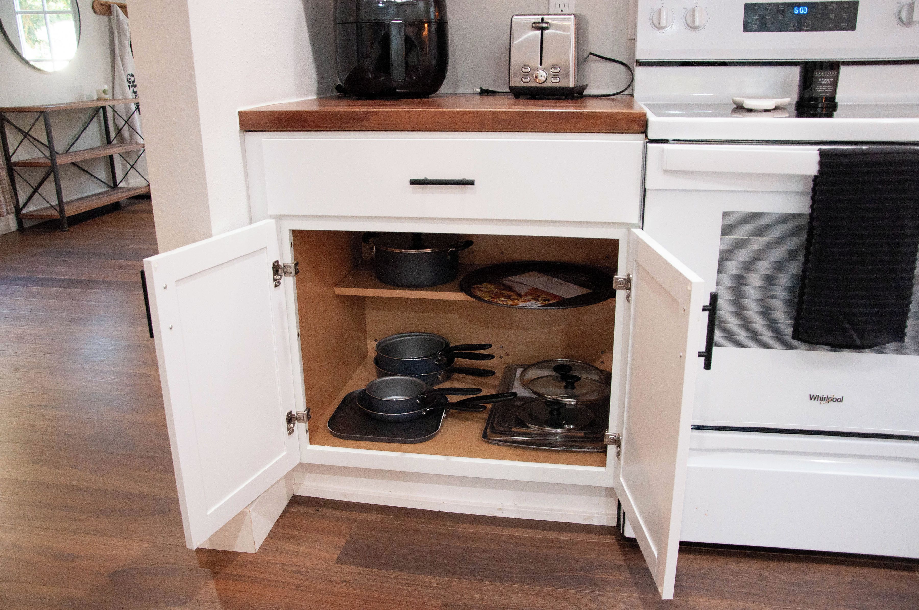 A kitchen with a white stove, a toaster, and a coffee maker on the countertop.