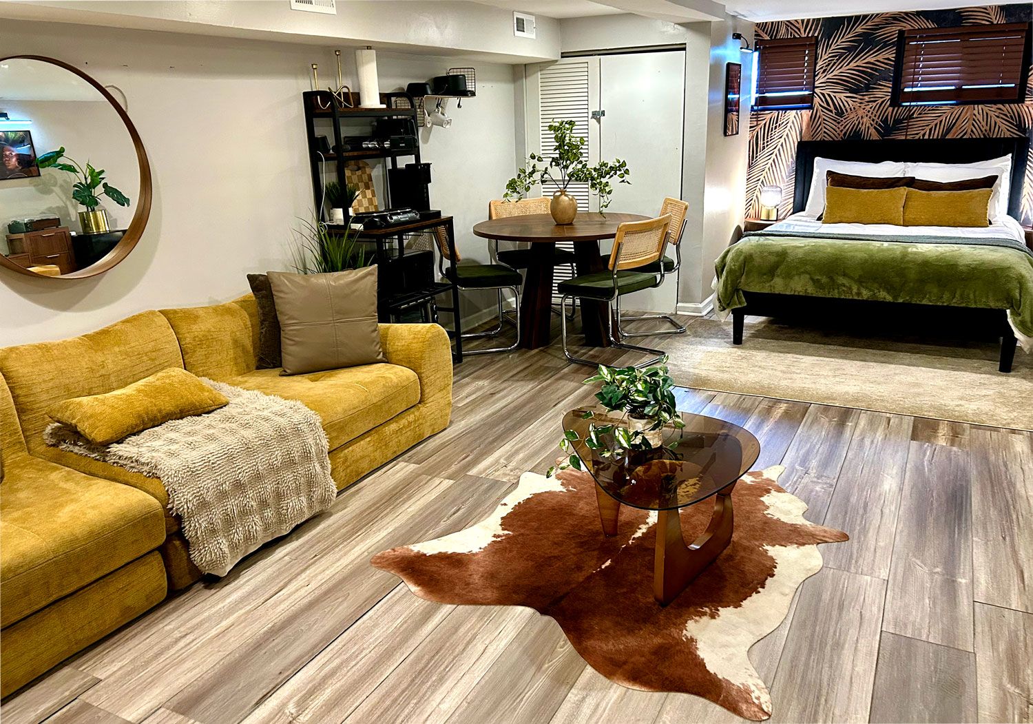 A living room with a sofa, coffee table, and a cowhide rug.