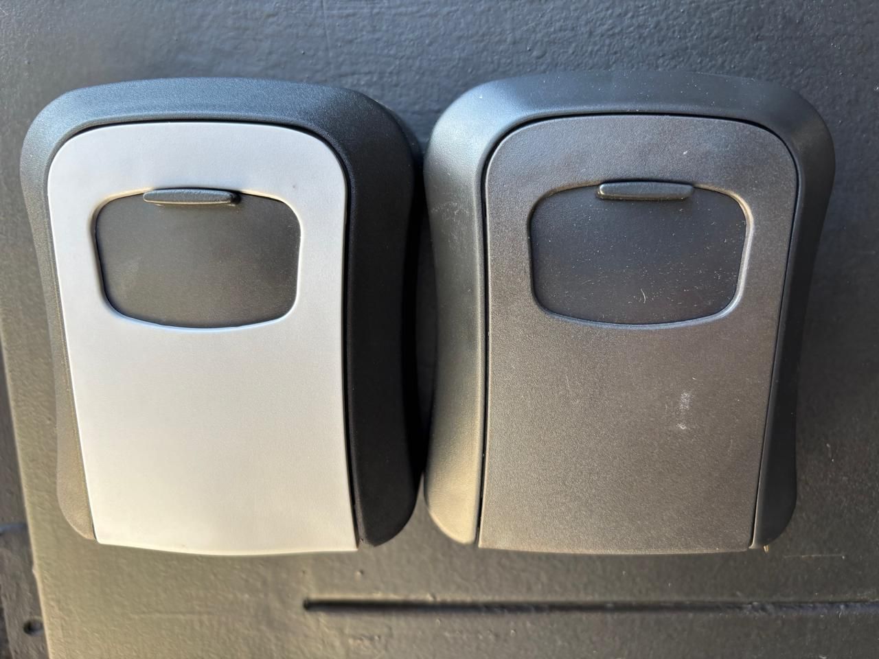 Two control buttons on a vehicle's dashboard.