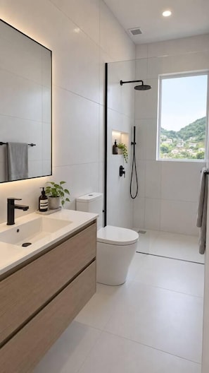 Ein modernes Badezimmer mit großem Spiegel, Waschbecken, Toilette und Dusche.