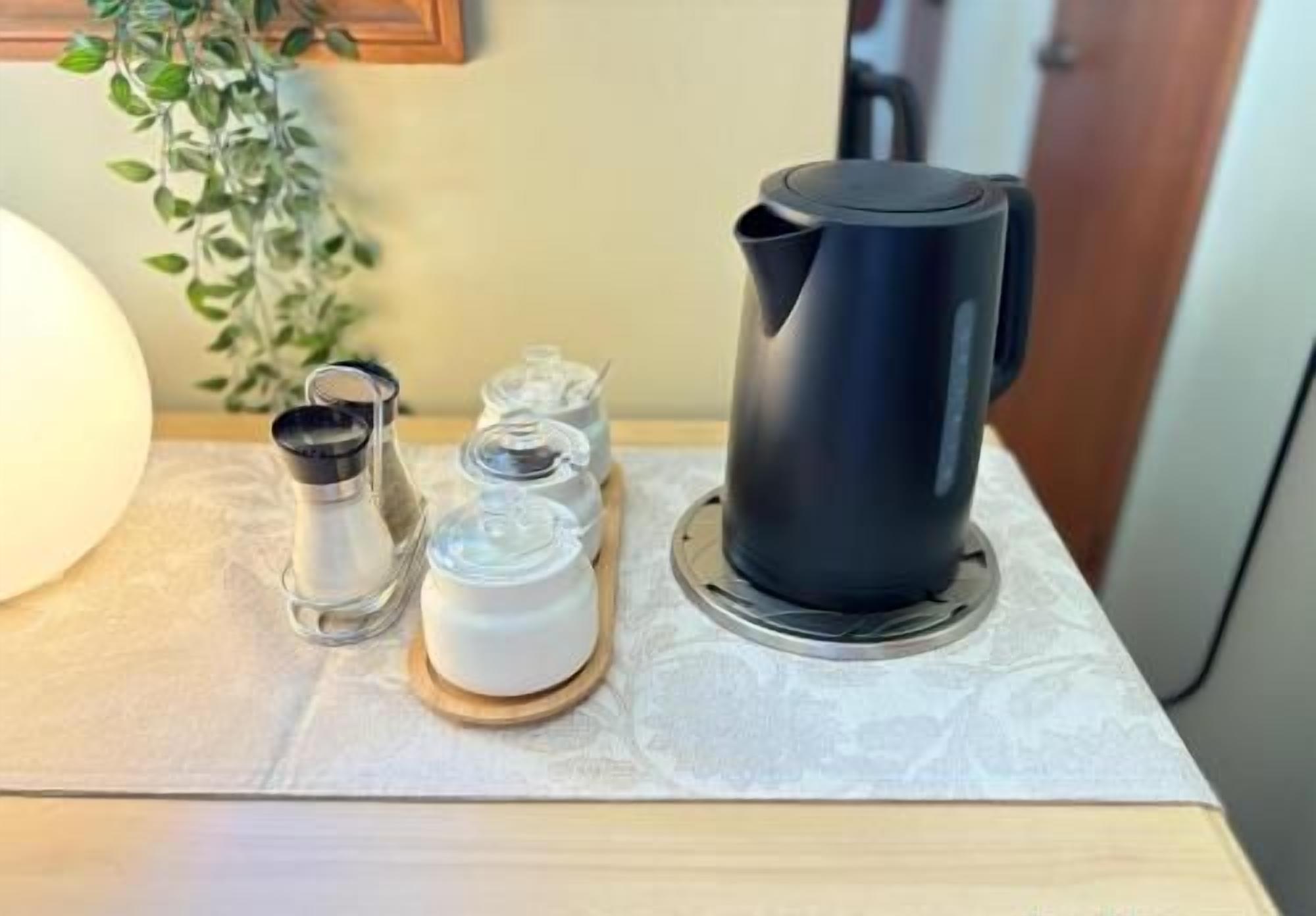 Convenient in-room tea station with modern kettle and cozy touches